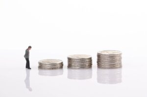 Businessman with coin stacks
