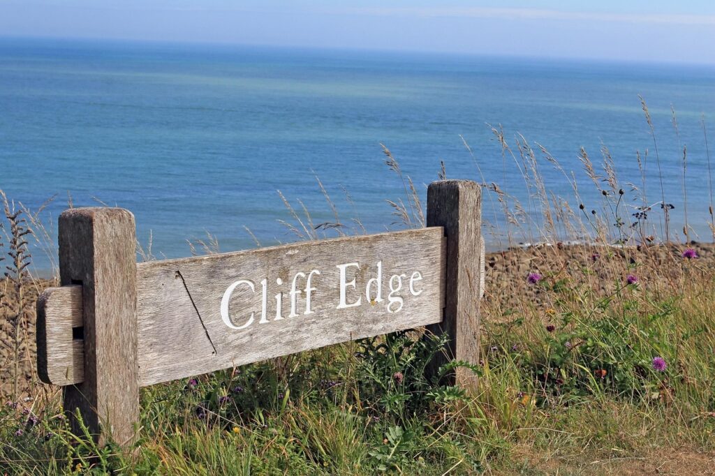 Sign at the edge of a cliff that says "Cliff Edge"